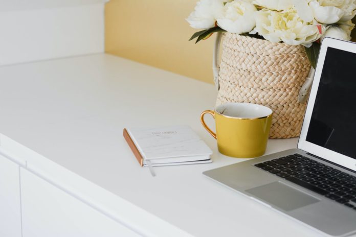 pexels-photo-2967810 yellow mug besides laptop