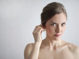 topless woman holding her ears
